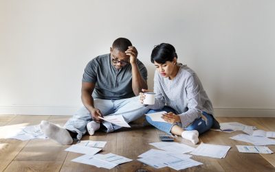 Couple managing a pile of debt papers