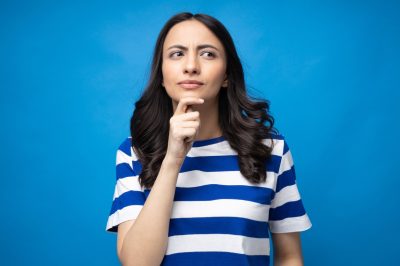 Portrait of young woman wear trendy smart casual outfit isolated on blue background