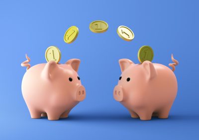 Two Pink piggy bank with coins on blue background