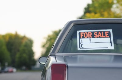 Car with for sale sign in window