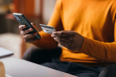 Man shopping on phone entering credit card information
