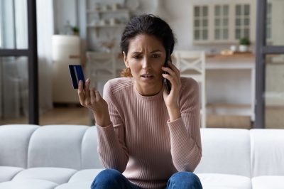Woman on phone calling credit card company after her credit limit decreased