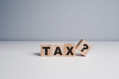 Wooden blocks with the word Tax and a question mark. Business and finance concept. Taxes and taxation. the tax burden