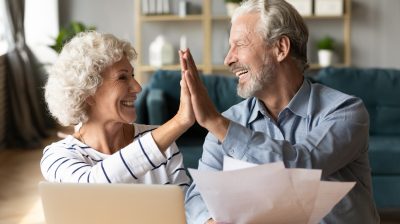 Excited older couple giving high five