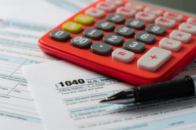 US tax form with pen and calculator