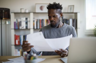 Man comparing loan options at table