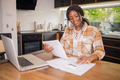 Young woman at computer applying for loan online