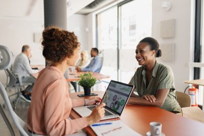 Woman applying for loan talking with banker about credit score impact