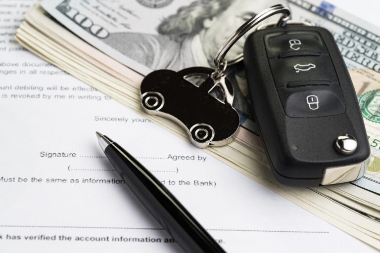 Car keys, American cash, and loan agreement