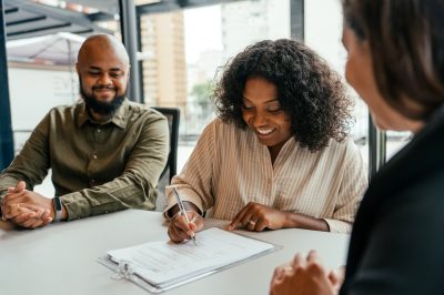 Woman signing loan agreement