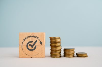 refinance and approved sign on wooden cube blocks , stack of coins, copy space included