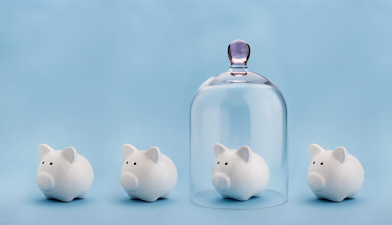 Piggybank protected under a glass dome on blue background