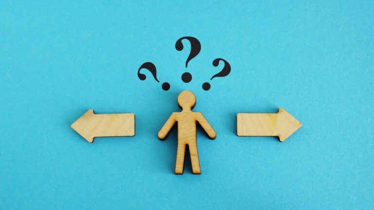 Wooden figure with 2 options. Concept of choosing between debt settlement and court