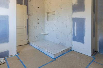 Renovation construction of master bathroom with new under construction bathroom interior drywall ready for tile