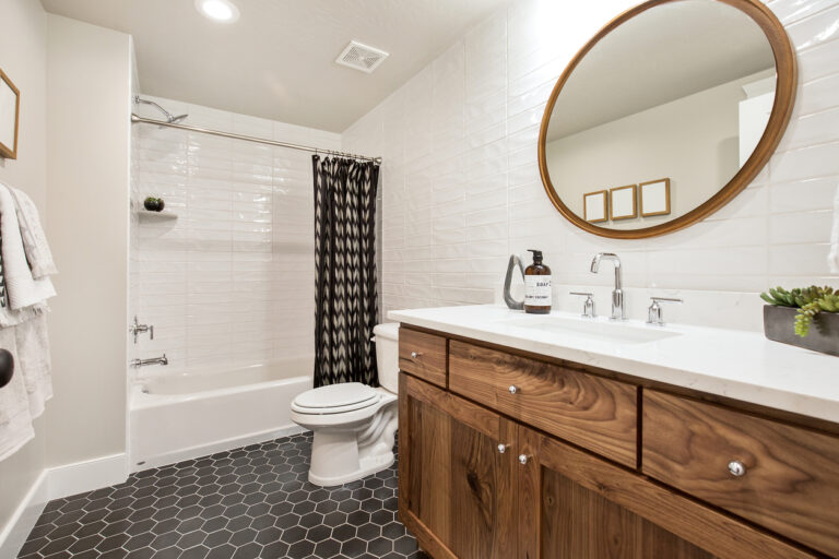 Brown, black and white are the prominent colors in this updated small bathroom