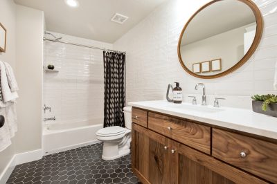 Brown, black and white are the prominent colors in this updated small bathroom