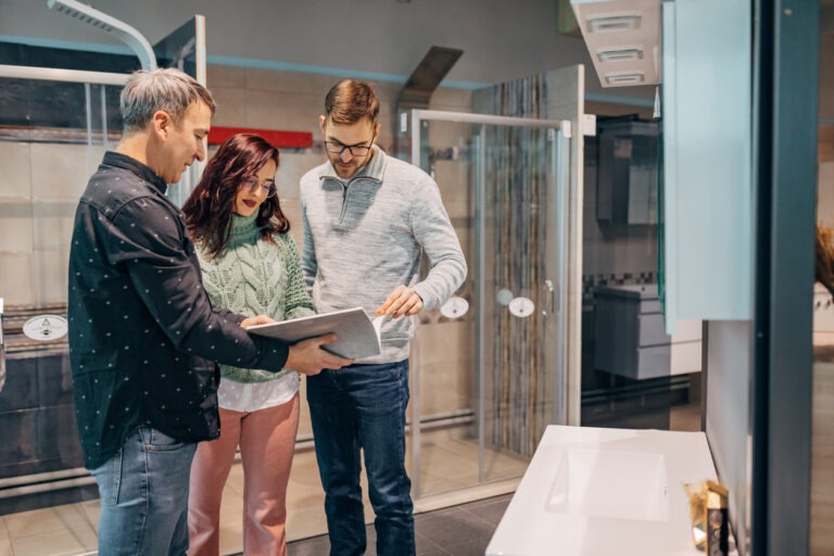 Bathroom remodeler working with clients showing shower options
