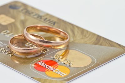 Wedding rings sitting on mastercard credit card
