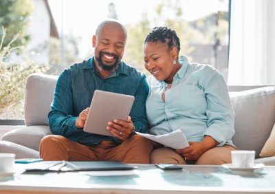 Couple on couch looking at loan prequalification letter