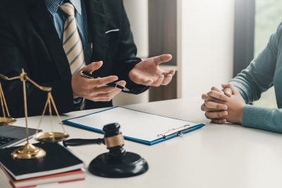 Image of lawyer at desk explaining information to client
