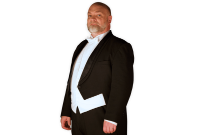 The Conductor wearing a full tuxedo with coattails