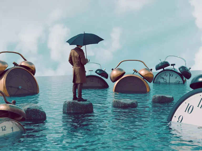 Man with umbrella walking on stones